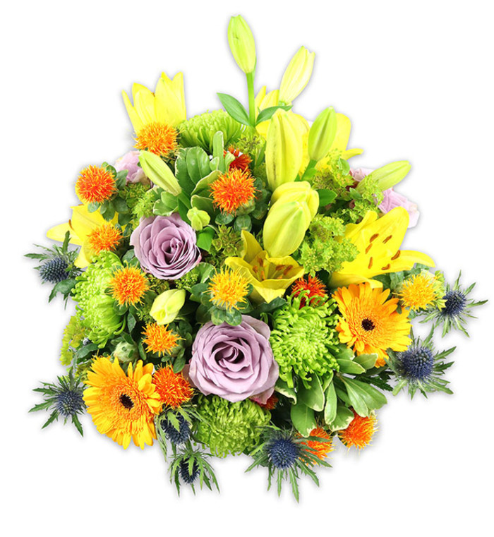 A densely arranged, colorful bouquet photographed on a plain white field, its composition celebrating contrast and texture with calm precision. Several lemon-yellow Asiatic lilies form a sculptural vertical line, their speckled throats and unfurled petals catching the eye, while elongated yellow-green buds reach up like promises of more blooms. Two gentle lavender roses supply a central, soothing focus - their layered petals unfolding in a soft spiral that calms the brighter notes. Scattered among them, vivid orange Gerbera daisies read like little suns with dark centres, and abundant chartreuse button chrysanthemums create cushiony, ruffled mounds that add both volume and a fresh, verdant tone. Tiny, spherical, spiky orange and golden yellow accent flowers add playful punctuation and a slightly prickly texture, and the distinctive blue-grey sea thistles (Eryngium) appear along the lower and side edges, their bracted forms supplying a striking cool counterpoint to the warmth of the other blooms. A tapestry of greens - from broad lily leaves to smaller glossy fillers - unifies the composition and gives the bouquet a natural, garden-fresh feeling despite the studio setting. Soft directional light sculpts the petals and casts delicate shadows on the white background, enhancing the sense of depth and the tactile differences between silky rose petals, satiny lily tepals and the rougher thistle bracts. The overall effect is joyful and refined, suitable for celebrations or comfort, and would look at home on a dining table in a Keston cottage or as a cheerful gift delivered to neighbours across Bromley and nearby Hayes. The bouquet communicates optimism, gratitude and carefully considered design.